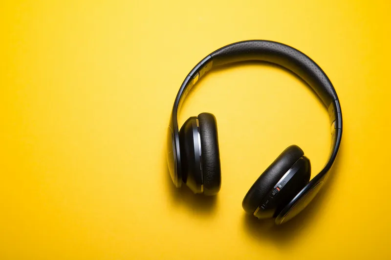 PULSE ANC over-ear headphones in yellow on a vivid background