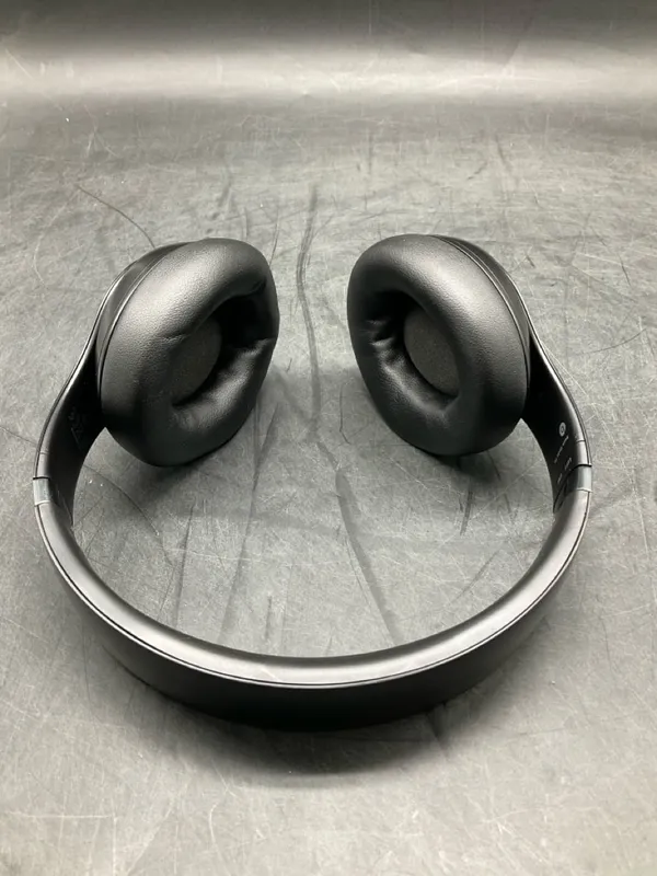 STUDIO monitor headphones viewed from above on a gray surface